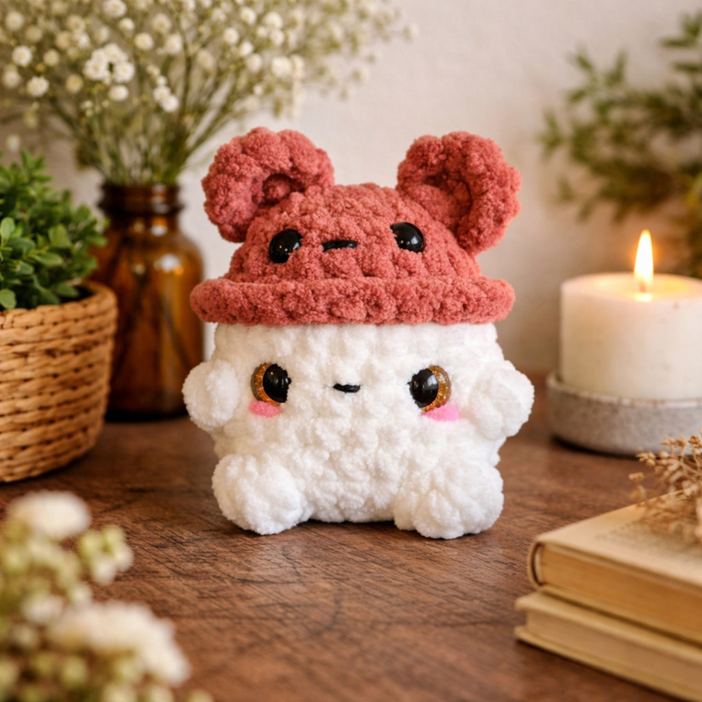 Handmade crochet bear mushroom plush on wooden table with cozy cottage core decor setting