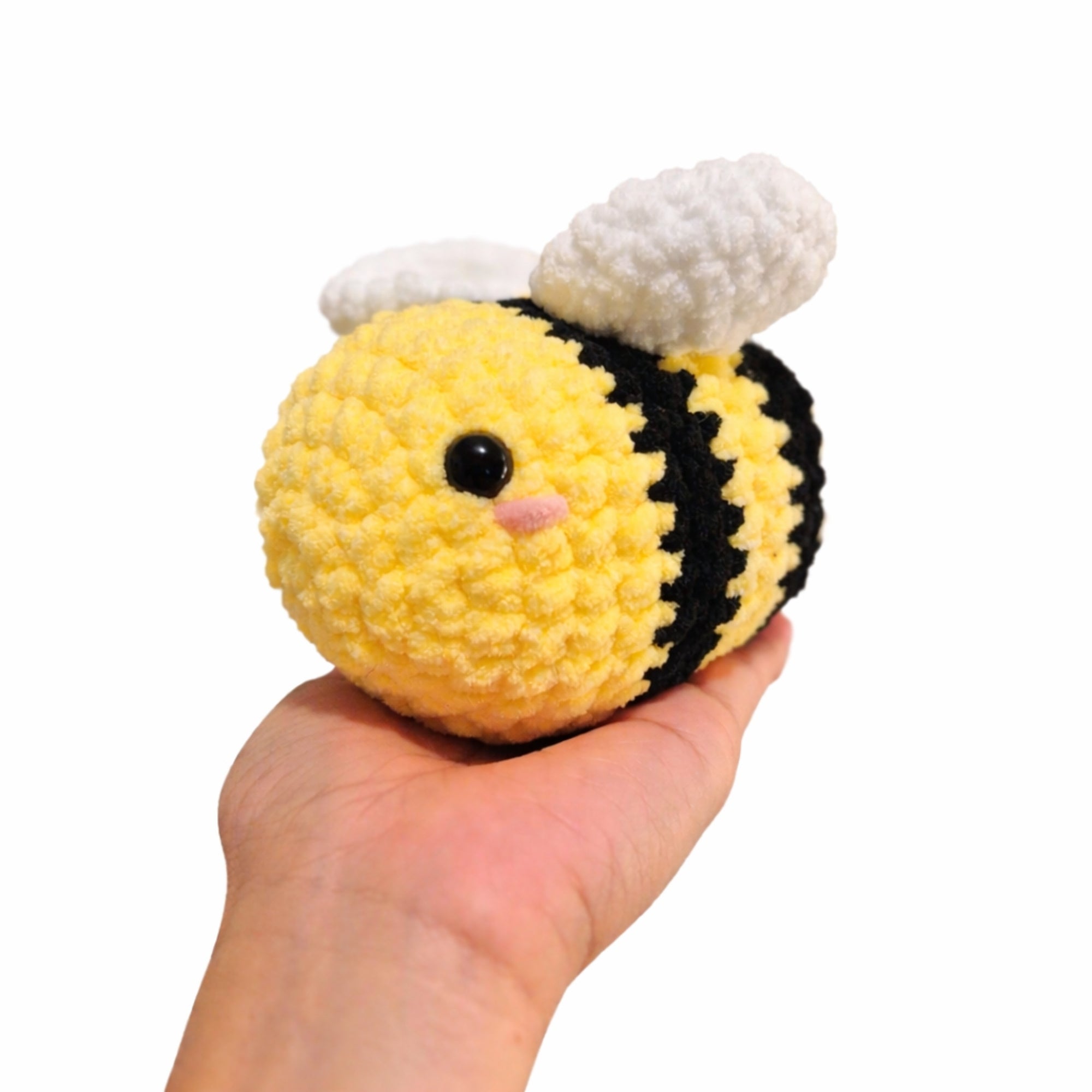 small crochet bee plush toy in hand