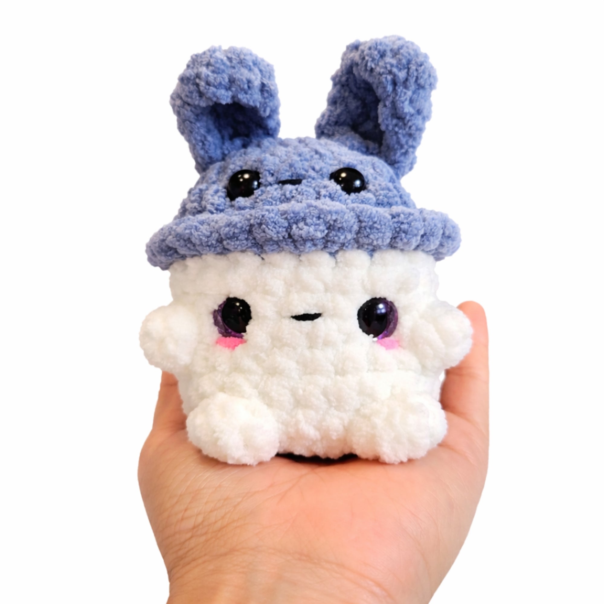 Handmade crochet bunny mushroom plush shown in hand for size reference