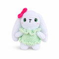 Handmade crochet bunny plush wearing a green dress with pink bow, cute amigurumi rabbit doll.