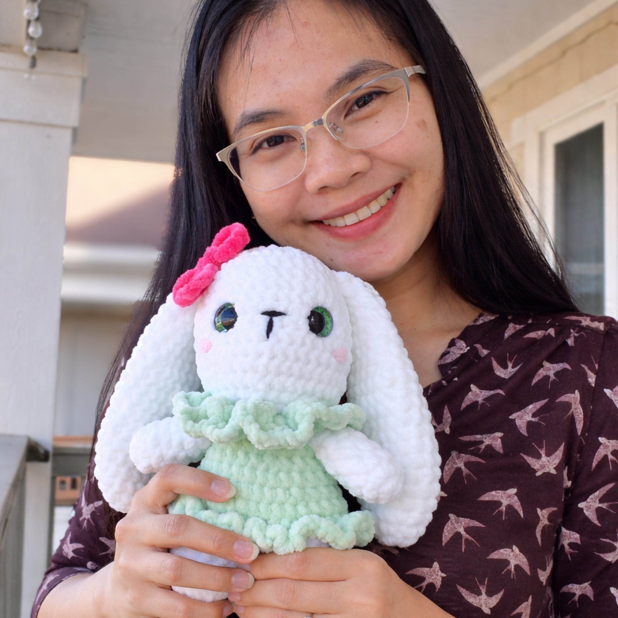Handmade crochet bunny plush shown in hand for size reference.