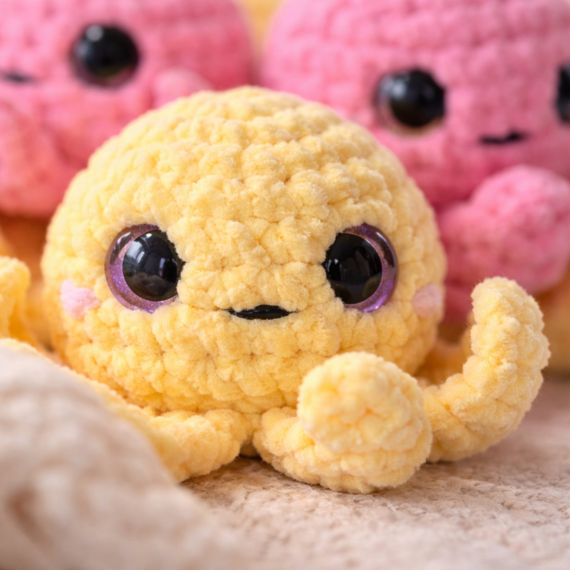 Close-up texture of handmade yellow crochet octopus plush amigurumi toy with soft yarn and cute face