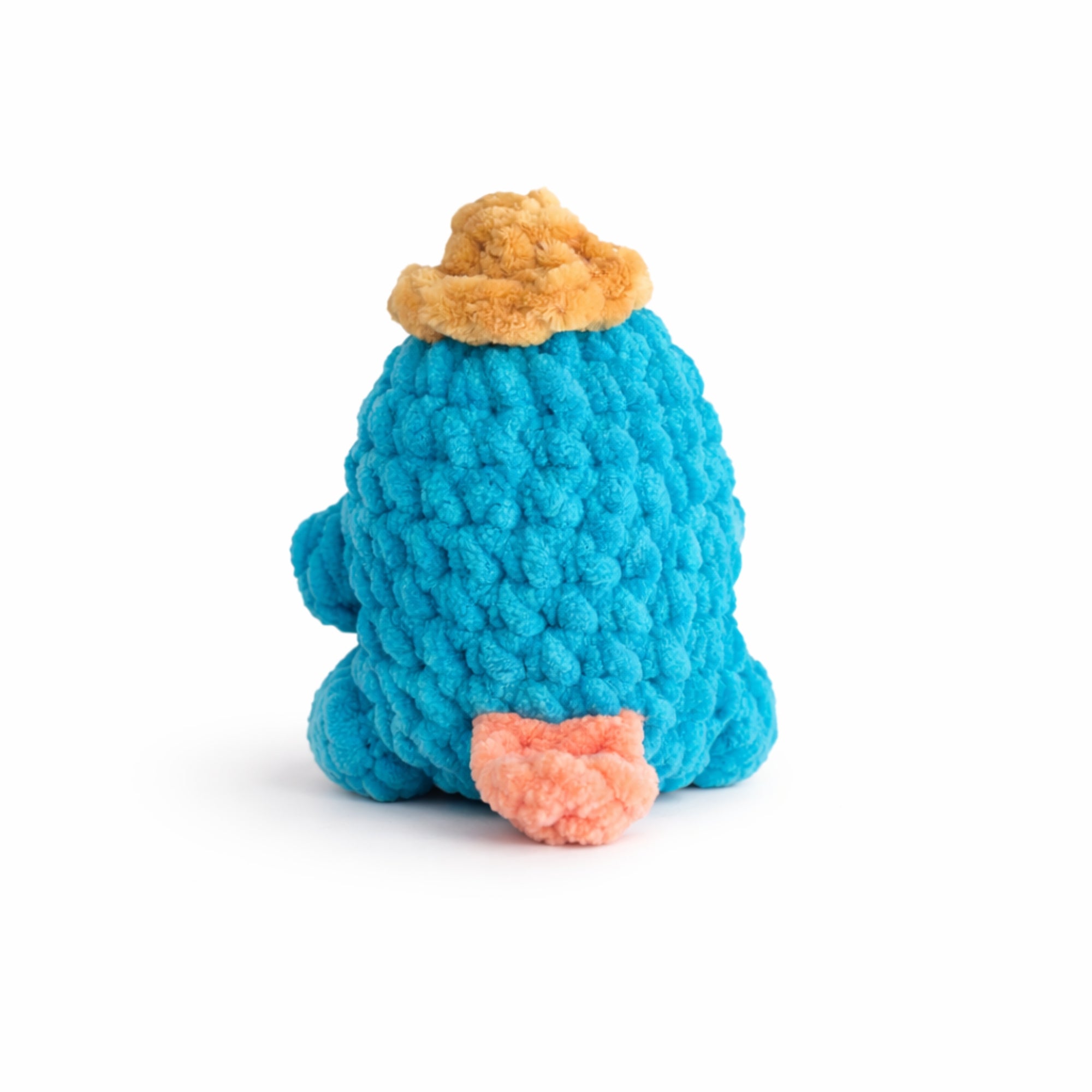 Back view of handmade crochet platypus plush amigurumi toy with soft chenille yarn.