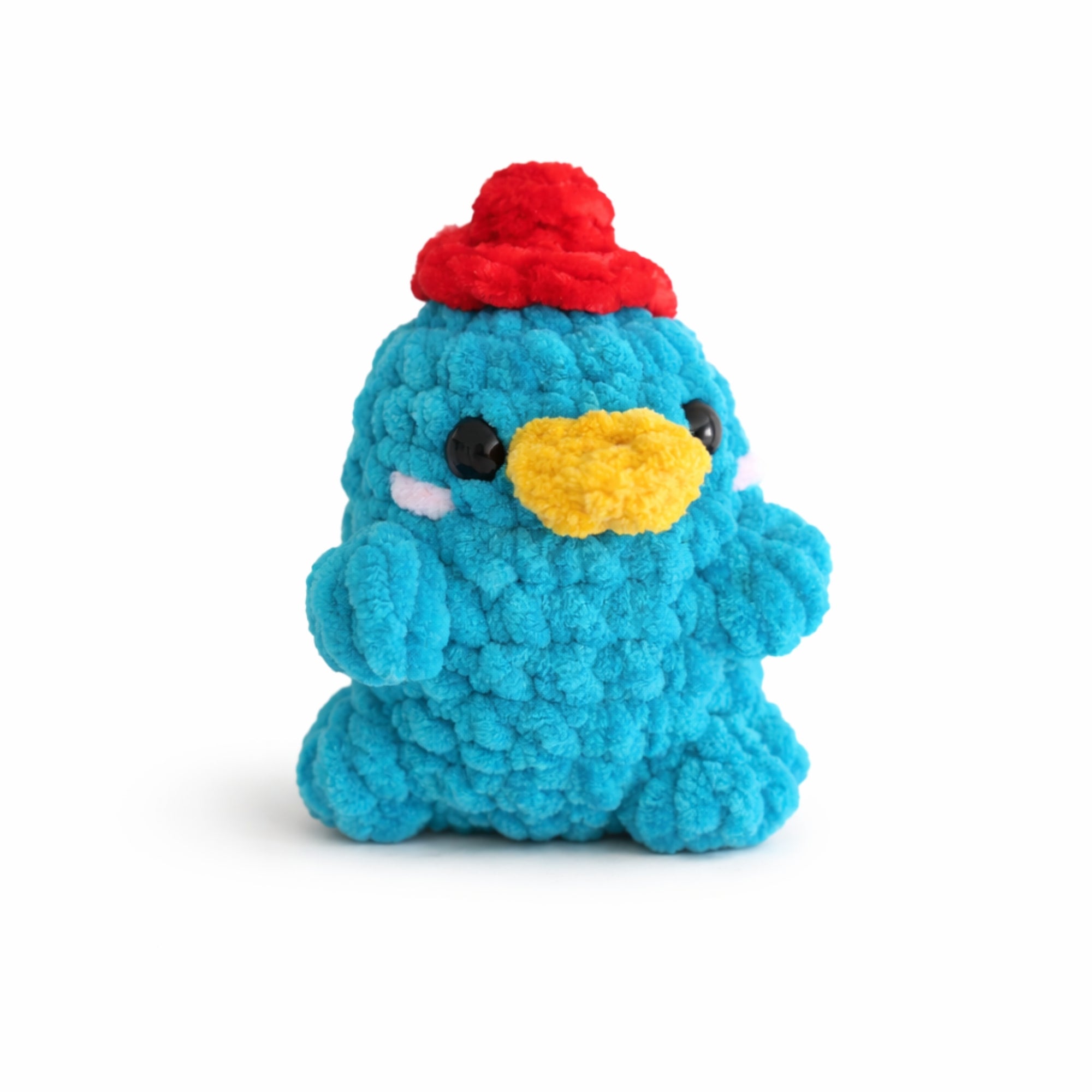 Handmade crochet platypus plush with red hat, soft chenille amigurumi toy.