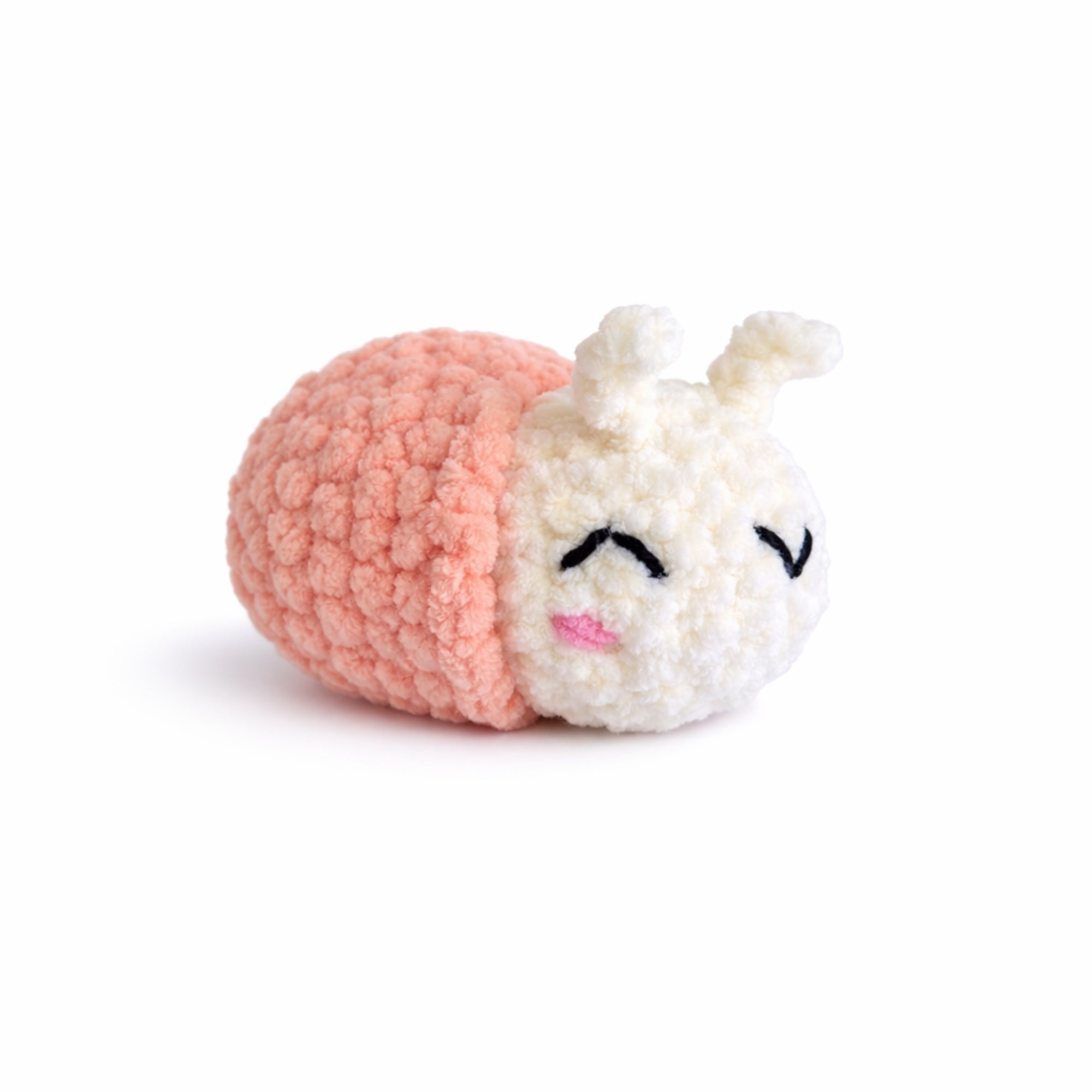 Handmade crochet snail amigurumi plush with peach shell.