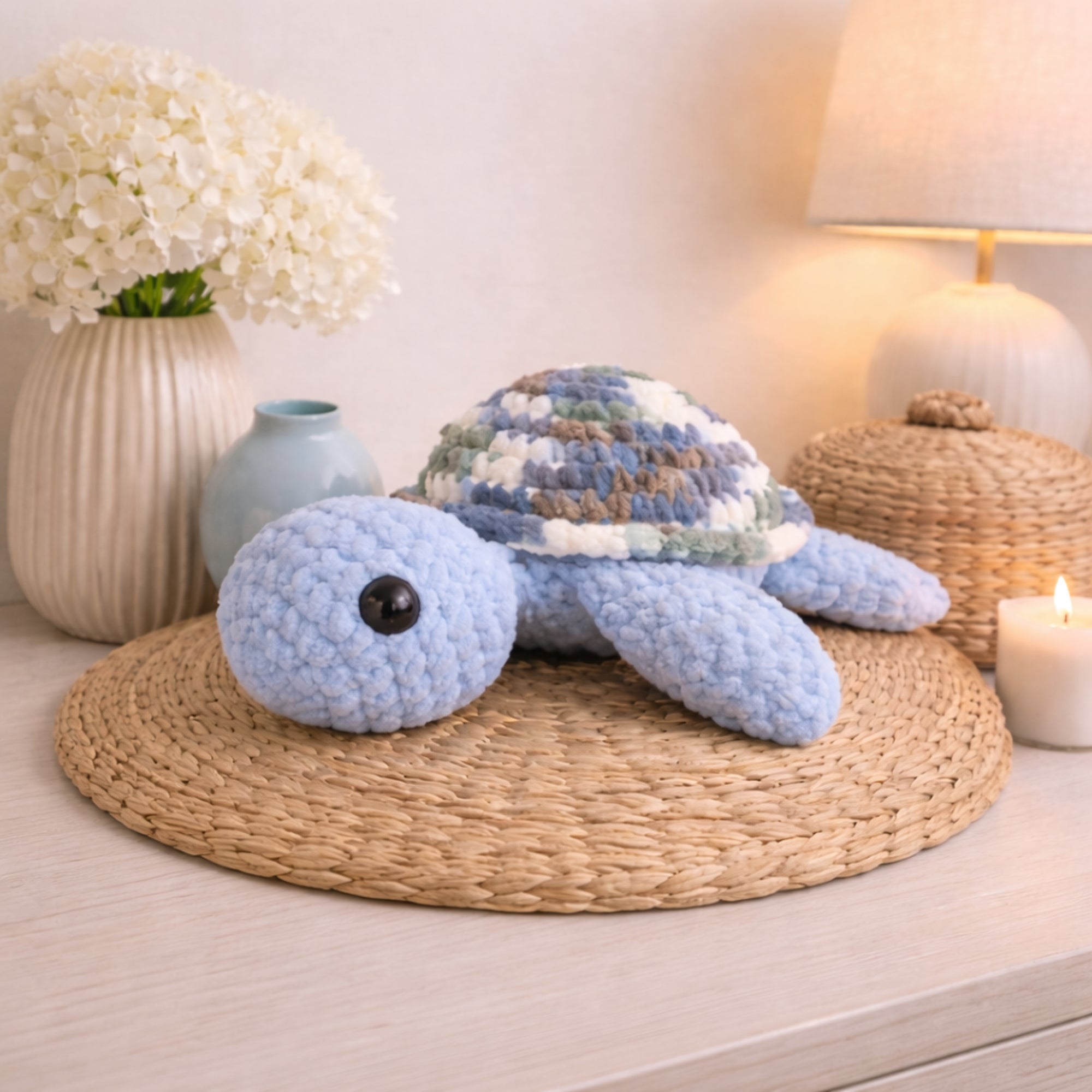 Handmade crochet turtle plush displayed as cozy home decor on a table with flowers and lamp
