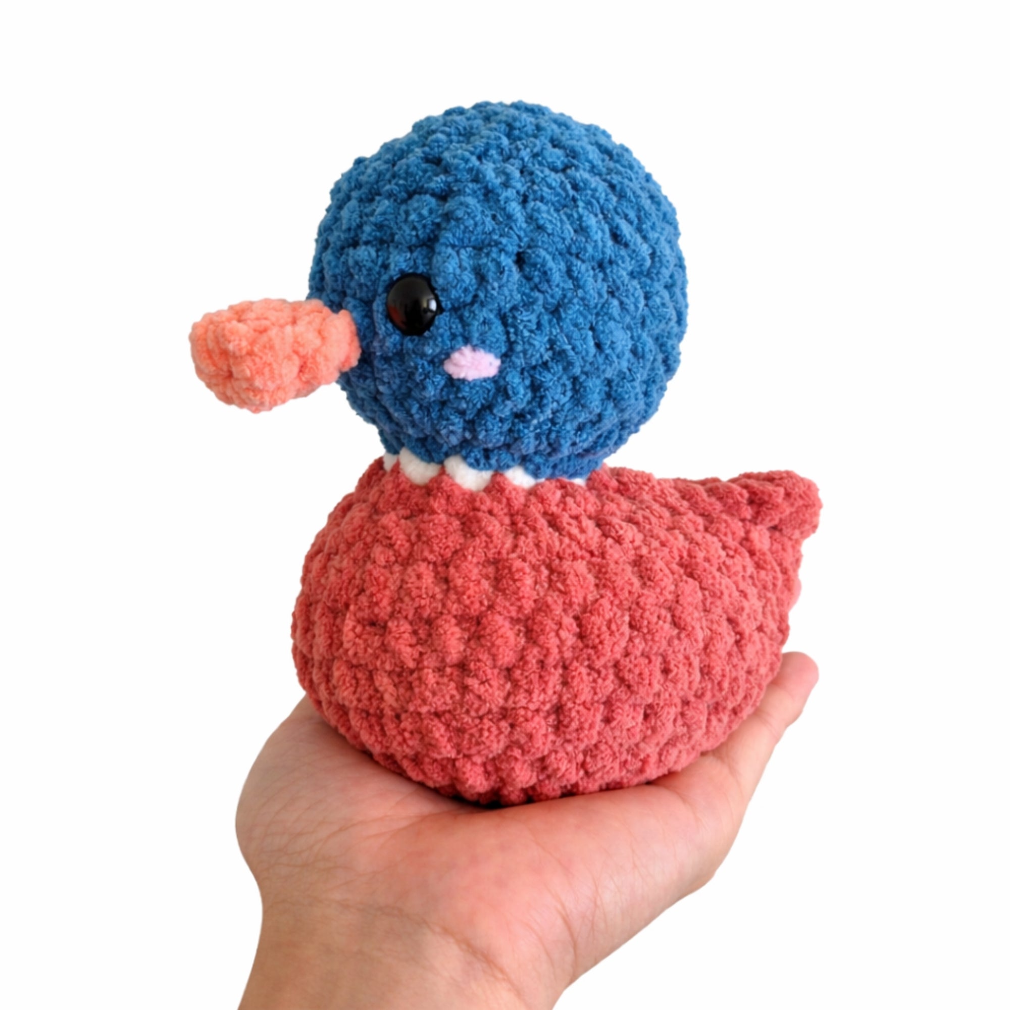 Handmade crochet duck amigurumi plush toy shown in hand for size comparison