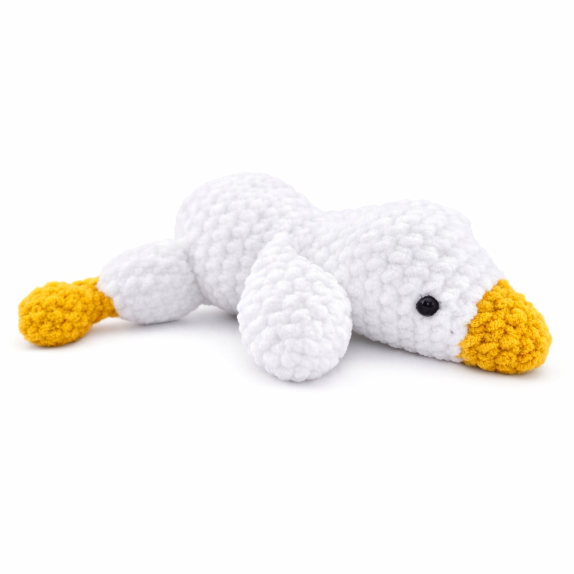 Handmade crochet goose amigurumi plush toy made with soft chenille yarn on white background