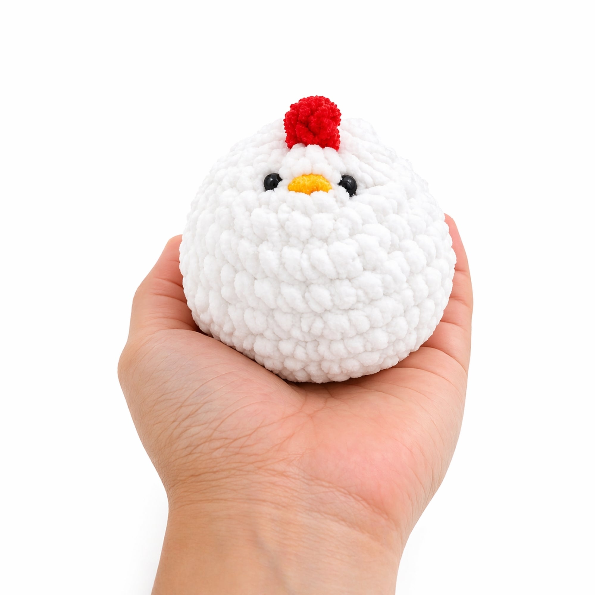 Happy Hen crochet plush in hand on white background, handmade amigurumi chicken toy soft fluffy mini hen approx 3 inches tall
