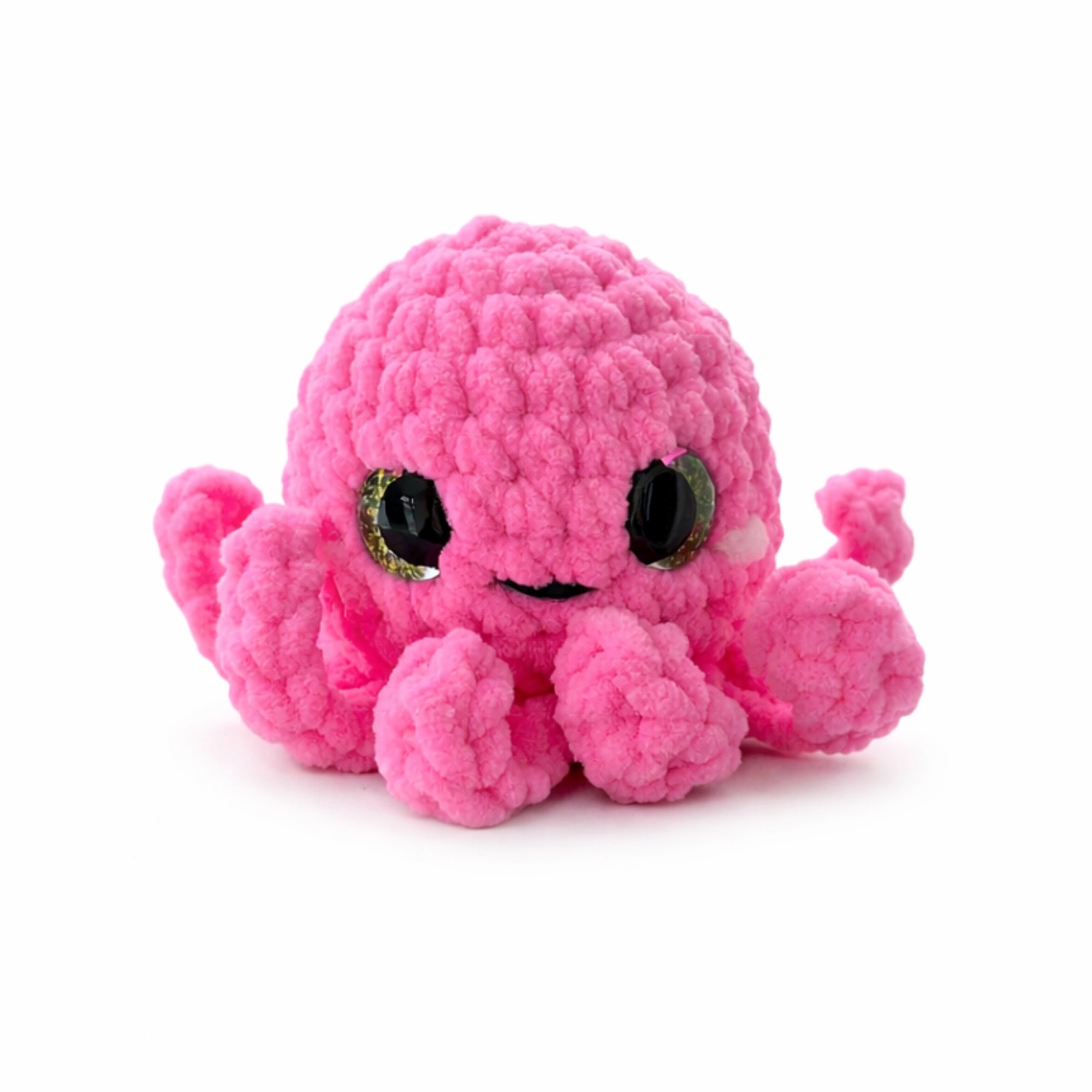 Cute pink crochet octopus amigurumi plush toy isolated on white background